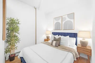 a bedroom with a bed and two plants at 139-2E west village 1BR best value in New York