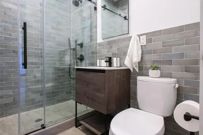 a bathroom with a toilet and a glass shower at 3-2 NEW Prime E Village Private outdoor! in New York