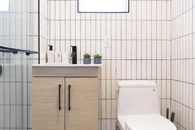 a bathroom with a toilet and a sink at 39-1 Renovated 3BR Prime Midtown West in New York