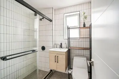 a bathroom with a toilet and a sink at 39-3 Newly renovated 3 BR Prime midtown sleeps 6 in New York