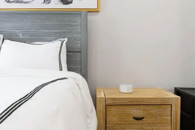 a bedroom with a bed and a nightstand with a cup on it at 350-2A Prime gramercy Newly renovated 1BR sleeps 4 in New York