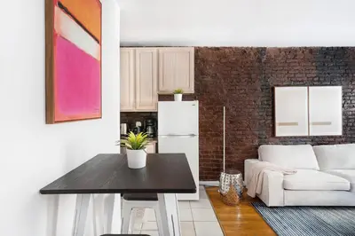 a kitchen and living room with a table and a couch at 350-1A Gramercy New 1BR Sleeps4 Newly Furnished in New York