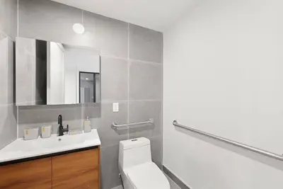 a bathroom with a white toilet and a sink at 149BK-101 New construction 2BR Private garden W-D in Brooklyn