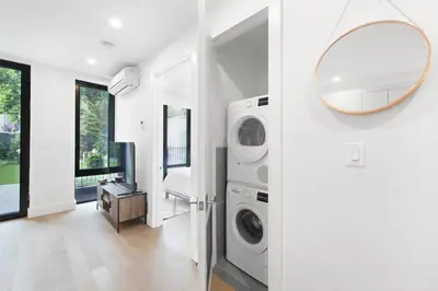 a laundry room with a washer and dryer and a mirror at 149BK-101 New construction 2BR Private garden W-D in Brooklyn