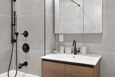 a bathroom with a sink and a shower at 149BK-101 New construction 2BR Private garden W-D in Brooklyn