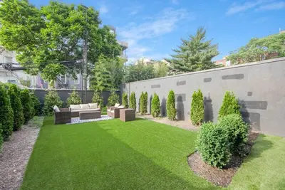 a garden with a couch and a lawn at 149BK-101 New construction 2BR Private garden W-D in Brooklyn
