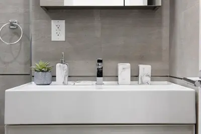 a bathroom with a white sink with a faucet at 78-4D Quality 1br W&D SKYLIGHT By Central Park in New York