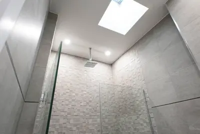 a bathroom with a shower with a skylight at 78-4D Quality 1br W&D SKYLIGHT By Central Park in New York