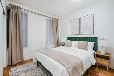 a bedroom with a large bed and a window at 109-1 Huge 3BR Best Value Amazing NYC Apt in New York