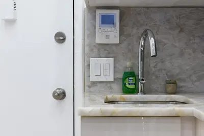 a kitchen sink with a green bottle of soap at 62-2B NEW Prime UES W D in unit in New York