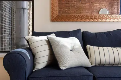 a blue couch with two pillows on it at 428-4R prime midtown large 2 BR Newly Furnished in New York