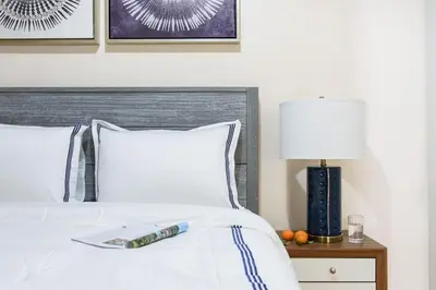 a bed with a book sitting on top of it at 428-4R prime midtown large 2 BR Newly Furnished in New York