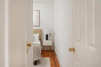 a room with a bed and an open door at 61-2A Large 1BR in Upper East Side in New York
