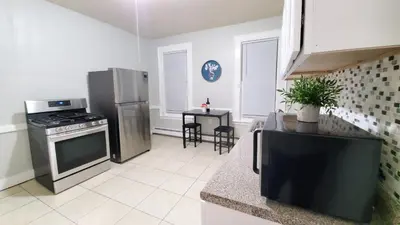 a kitchen with stainless steel appliances and a table at Room for rent in Apartment in Hartford