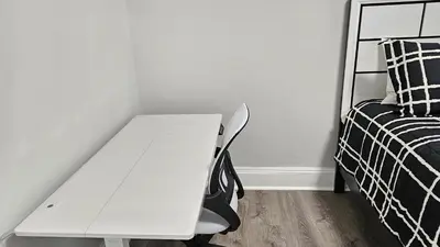 a white desk in a bedroom next to a bed at Room for rent in Apartment in Hartford