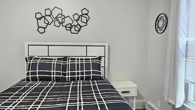 a bedroom with a bed with a black and white comforter at Room for rent in Apartment in Hartford