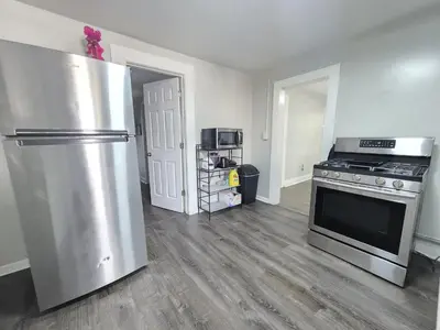 a kitchen with a stainless steel refrigerator and a stove at Room for rent in Apartment in Hartford