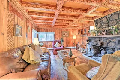 a living room with a leather couch and a fireplace at Old Time Catskill Mtn Retreat, Handcrafted Cabin! in Cornwallville