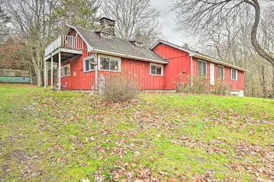 a red house sitting on top of a green field at Old Time Catskill Mtn Retreat, Handcrafted Cabin! in Cornwallville