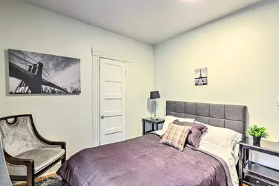 a bedroom with a bed and a chair at Hartford Vacation Rental - Close to Downtown! in Hartford