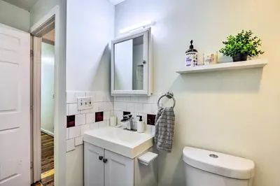 a bathroom with a toilet and a sink and a mirror at Hartford Vacation Rental - Close to Downtown! in Hartford