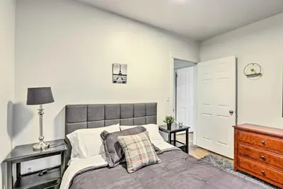 a bedroom with a bed and a dresser and a door at Hartford Vacation Rental - Close to Downtown! in Hartford