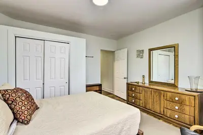 a bedroom with a bed and a mirror and a dresser at Hartford Vacation Rental - Close to Downtown! in Hartford