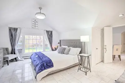 a white bedroom with a large bed and a window at Elegant Connecticut Home Fireplaces, Pet Friendly in Trumbull