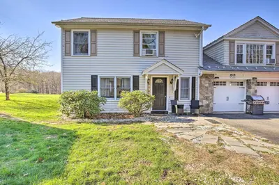 a gray house with a garage and a driveway at Elegant Connecticut Home Fireplaces, Pet Friendly in Trumbull