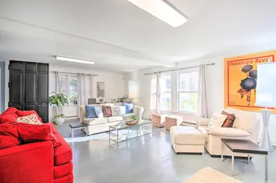 a living room with a red couch and white chairs at Elegant Connecticut Home Fireplaces, Pet Friendly in Trumbull