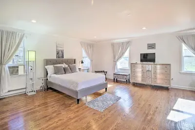 a bedroom with a bed and a television in it at Elegant Connecticut Home Fireplaces, Pet Friendly in Trumbull