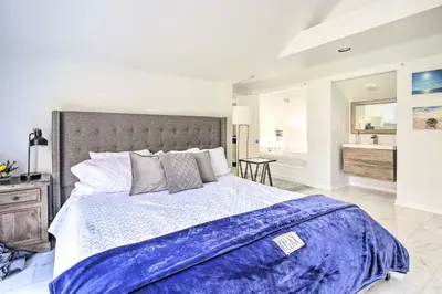 a bedroom with a large bed and a bathroom at Elegant Connecticut Home Fireplaces, Pet Friendly in Trumbull