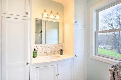 a bathroom with a sink and a mirror and a window at Elegant Connecticut Home Fireplaces, Pet Friendly in Trumbull
