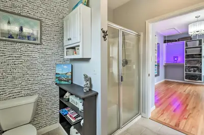 a bathroom with a toilet and a walk in shower at Calm Columbia Haven Outdoor Pool, Hot Tub! in Delaware Water Gap