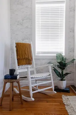 a white rocking chair in a room with a window at Farmhouse Broad Brook: Comfort & Charm. in East Windsor