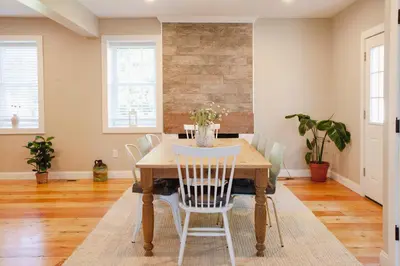 a dining room with a table and chairs at Farmhouse Broad Brook: Comfort & Charm. in East Windsor