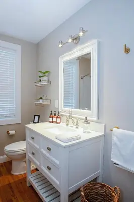 a bathroom with a sink and a mirror and a toilet at Farmhouse Broad Brook: Comfort & Charm. in East Windsor