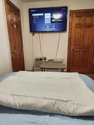 a bedroom with a bed and a tv on the wall at In the heart of nyc! Time sq, theater district, javits center in New York
