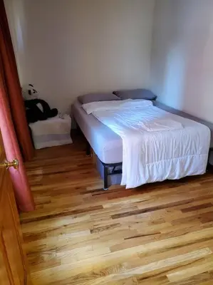 a bedroom with a bed and a wooden floor at In the heart of nyc! Time sq, theater district, javits center in New York
