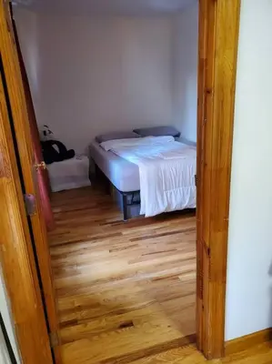 a door to a bedroom with a bed in a room at In the heart of nyc! Time sq, theater district, javits center in New York