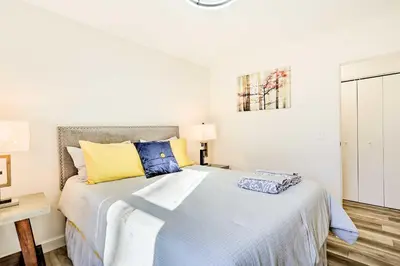 a bedroom with a bed with blue and yellow pillows at New Paltz Apt - 11 Mi to Poughkeepsie! in New Paltz