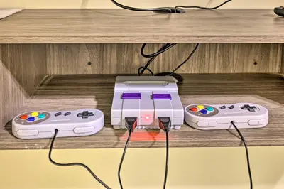 two video game consoles are sitting on a shelf at 3 Mi to Kalahari Pocono Summit Home with Game Room! in Pocono Summit