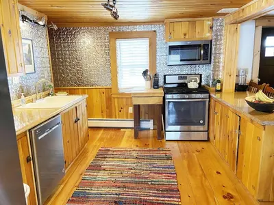 a kitchen with a sink and a stove top oven at FRENCH WOODS FARMHOUSE Catskills Upper Delaware River Hancock NY in Hancock