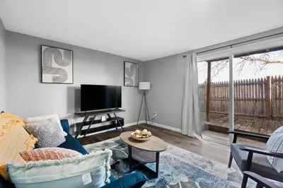 a living room with a blue couch and a tv at Lovely 3 Bedroom Colonial home in Middletown