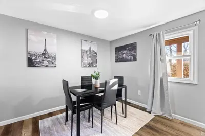 a dining room with a black table and chairs at Lovely 3 Bedroom Colonial home in Middletown