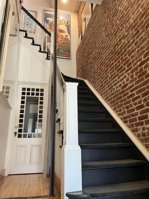 a staircase in a house with a brick wall at Modern loft style 2bed 2bath minutes to Times Square in West New York