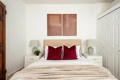 a bedroom with a large bed with red pillows at 61-2C Prime UES 2BR Newly furnished best value in New York