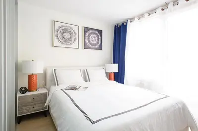 a white bedroom with a bed and a window at 75-1C New 1BR prime UES W D the unit Best Value in New York
