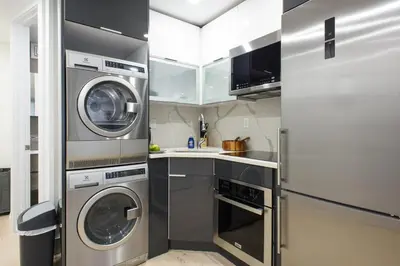 a kitchen with two washing machines and a sink at 75-1C New 1BR prime UES W D the unit Best Value in New York