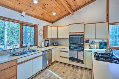 a kitchen with white cabinets and a wooden ceiling at Berkshires Cabin 2 Mi to Appalachian Trail! in Otis